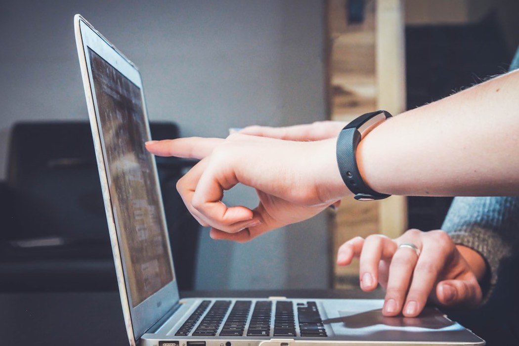 A person using an online file converter on a laptop