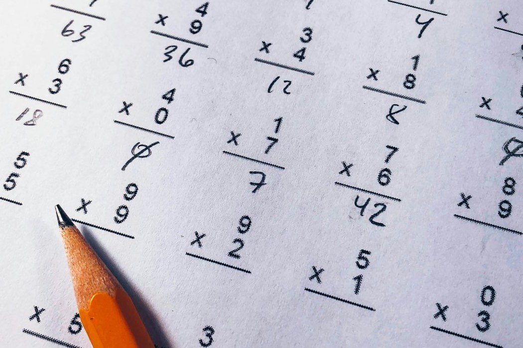 A ruler and notebook on a desk used for unit conversion